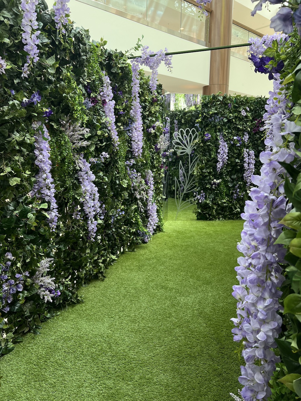 Custom greenery and wisteria green wall maze built as an interactive brand display.