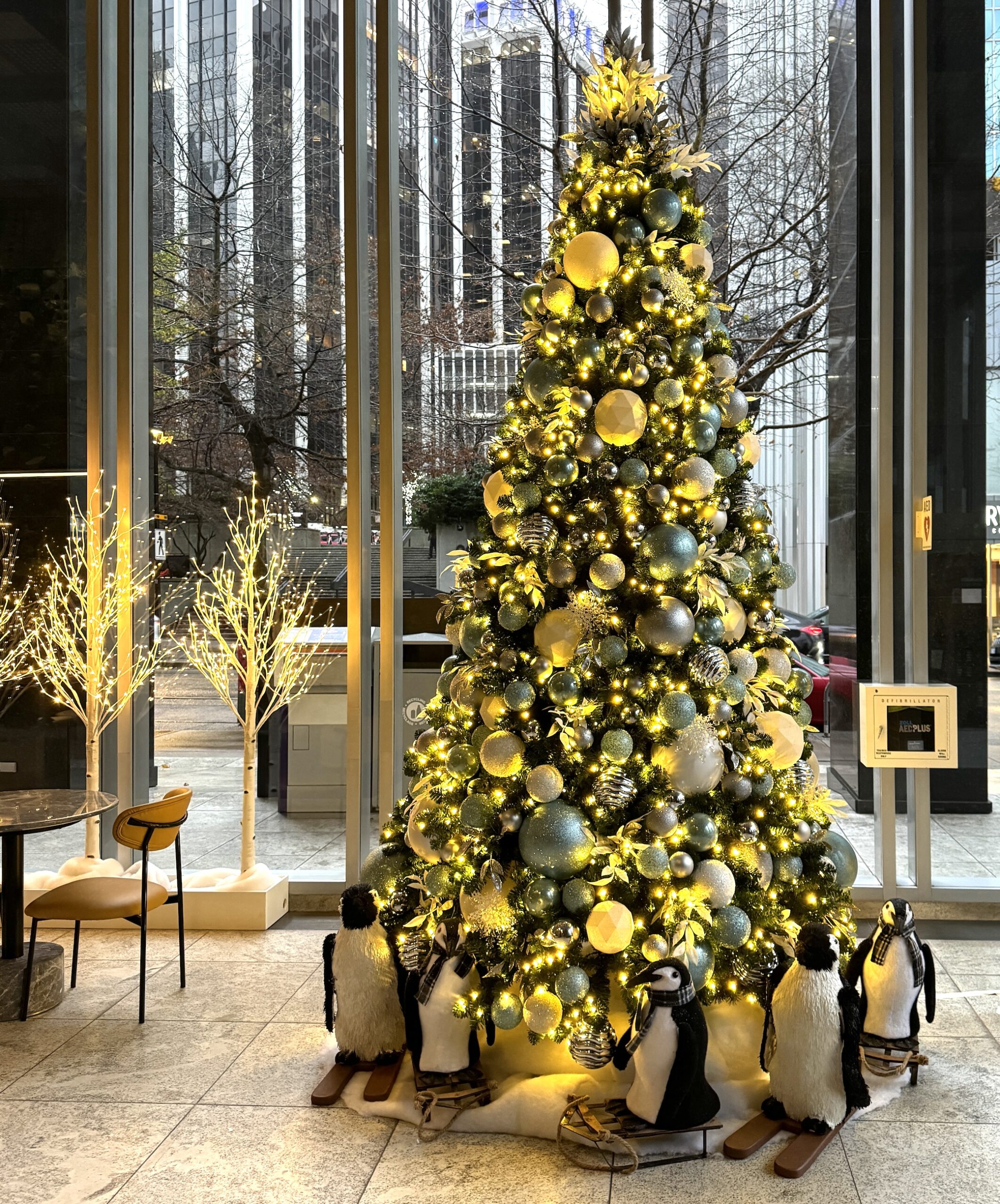 Icy blue artificial 12 foot Christmas tree installed for a Vancouver commercial rental.