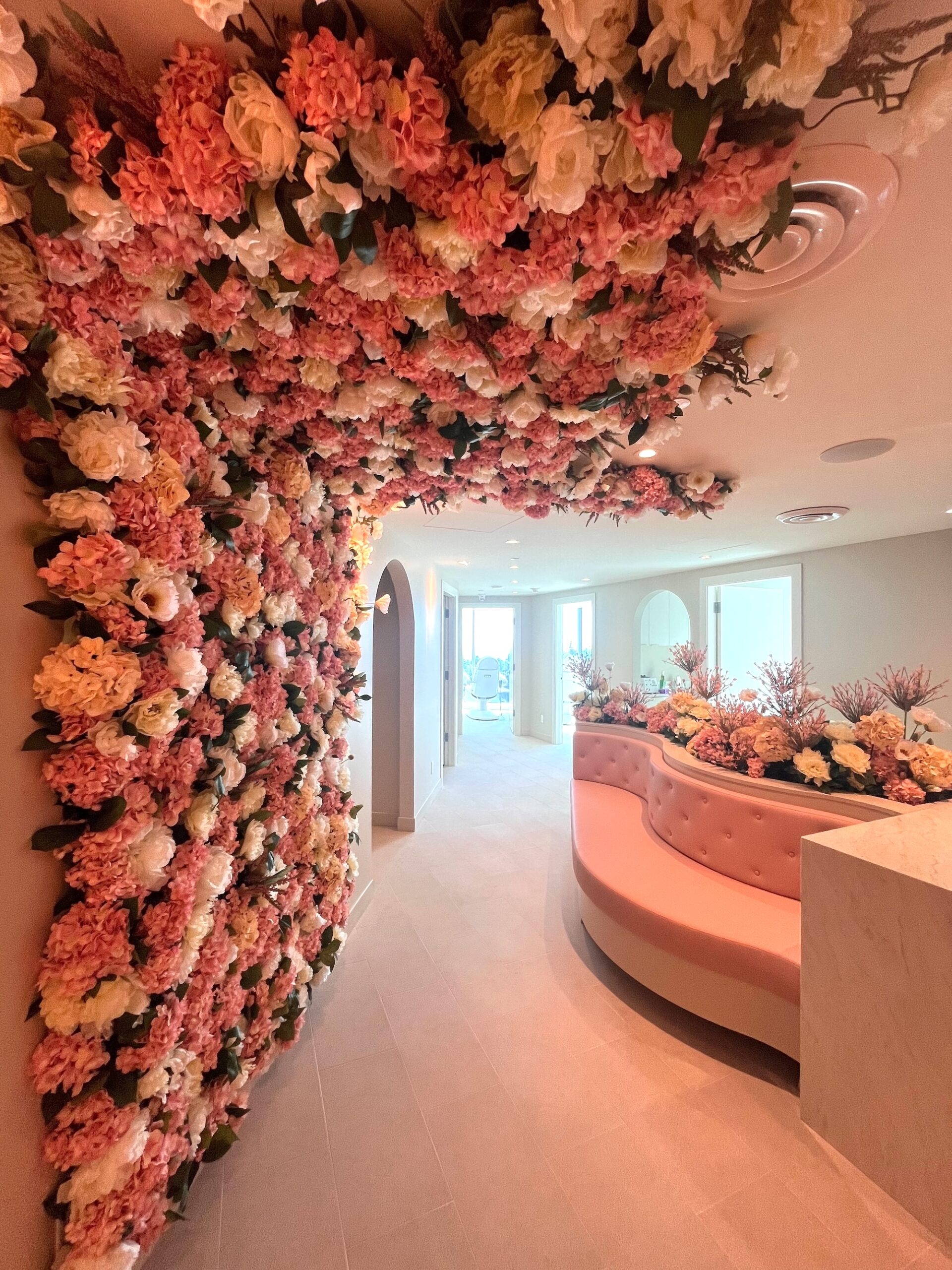 Floral wall and ceiling greenery installed in a medical office reception.